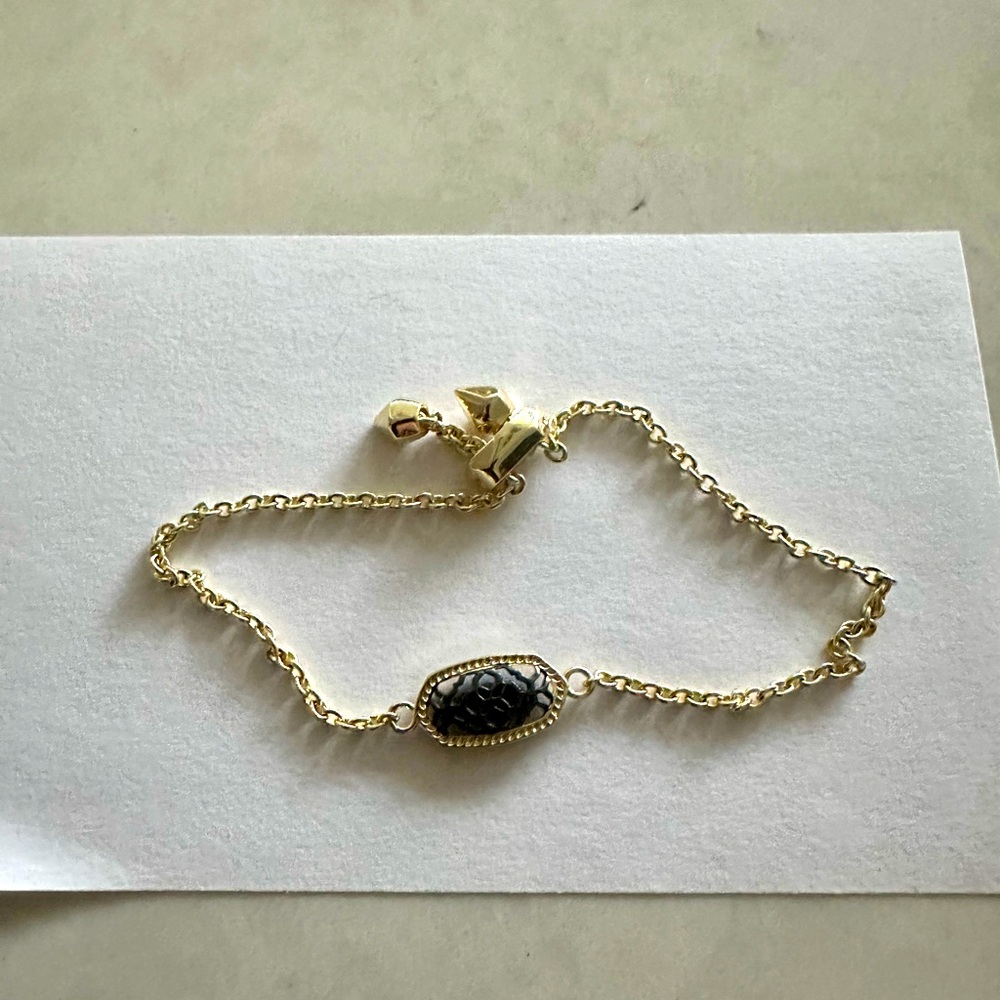 Kendra Scott gold and gunmetal bracelet.